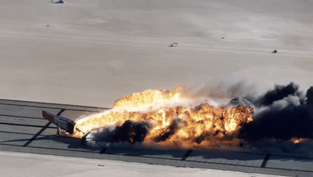 The Boeing 720 on fire after landing. 